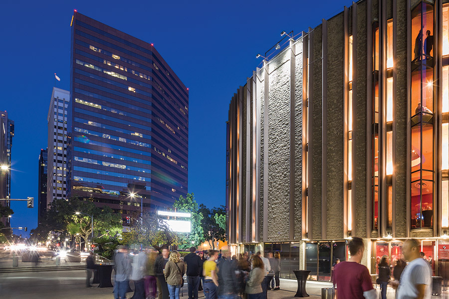Nighttime view of the Civic Theater from the plaza, showing arriving guests and surrounding downtown buildings.