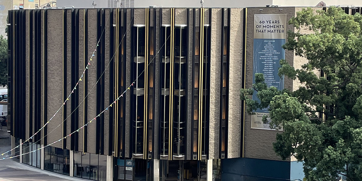 2025 exterior of the Civic Theater viewed from the plaza, featuring newly painted black and gold building blades.