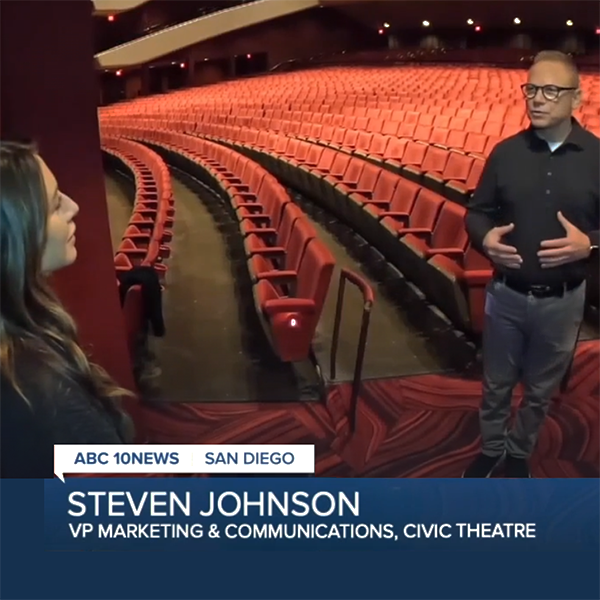 Reporter interviewing Steven Johnson inside the Civic Theater seating area, for an ABC 10News segment.