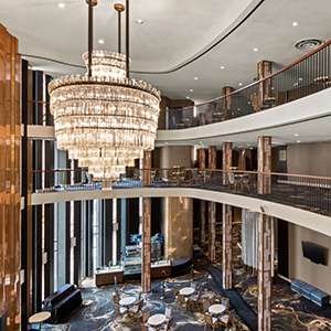 Interior view of the Civic Theatre Grand Salon from the balcony, showing ornate décor, chandeliers, and concession layout below.